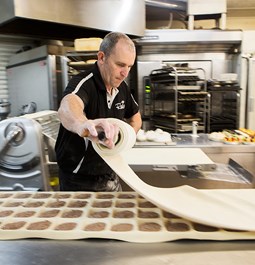 A baker preparing food at our bakery in the Geelong area
